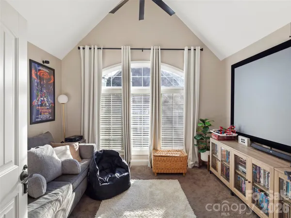 a bedroom with furniture and a large window