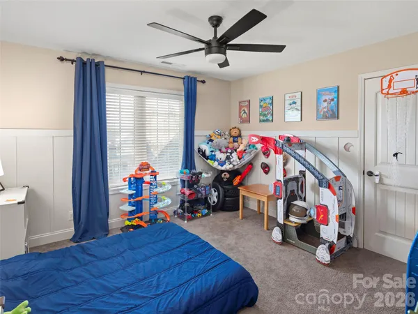 a children room with toys and a fan