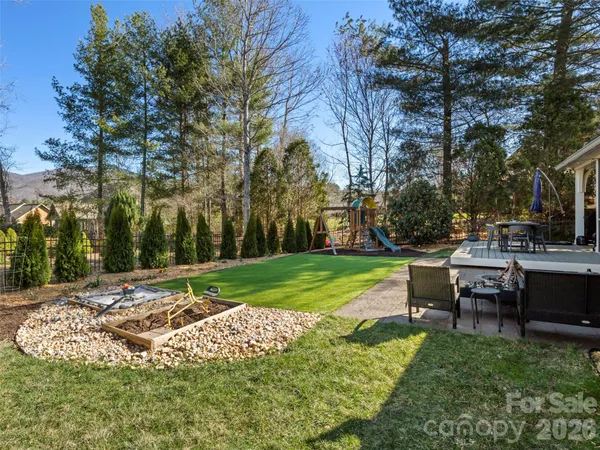 a view of a park with bench and trees