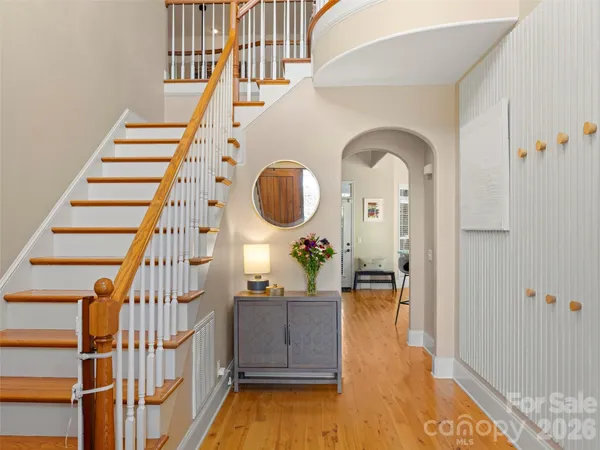a view of entryway and hall with wooden floor