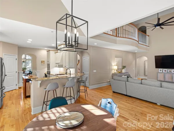 a living room with furniture and view of kitchen