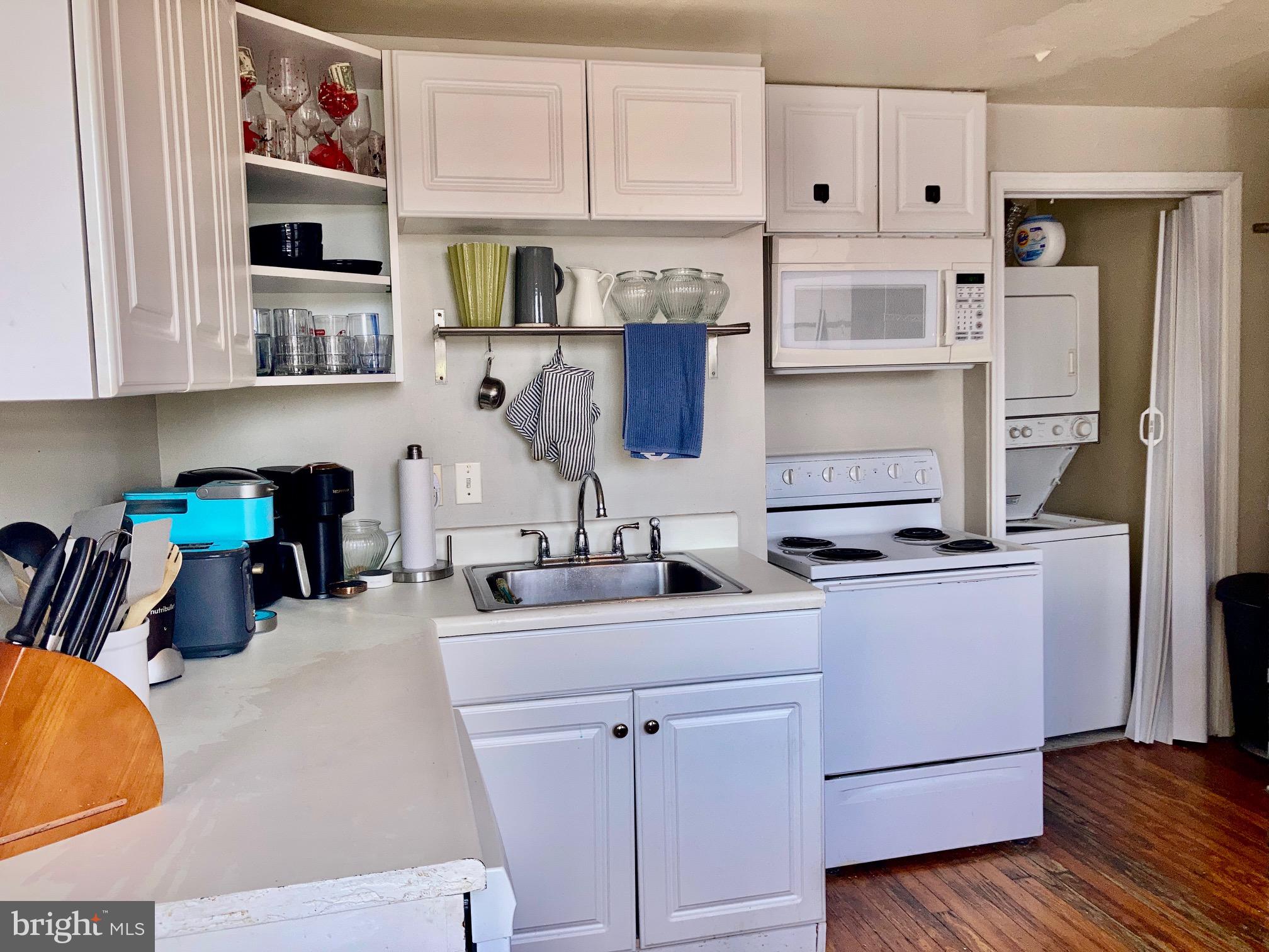 928-930 Pine Street, Unit 4R Philadelphia, PA 19107 - Photo 14 of 15 a kitchen with stainless steel appliances cabinets and a wooden floor