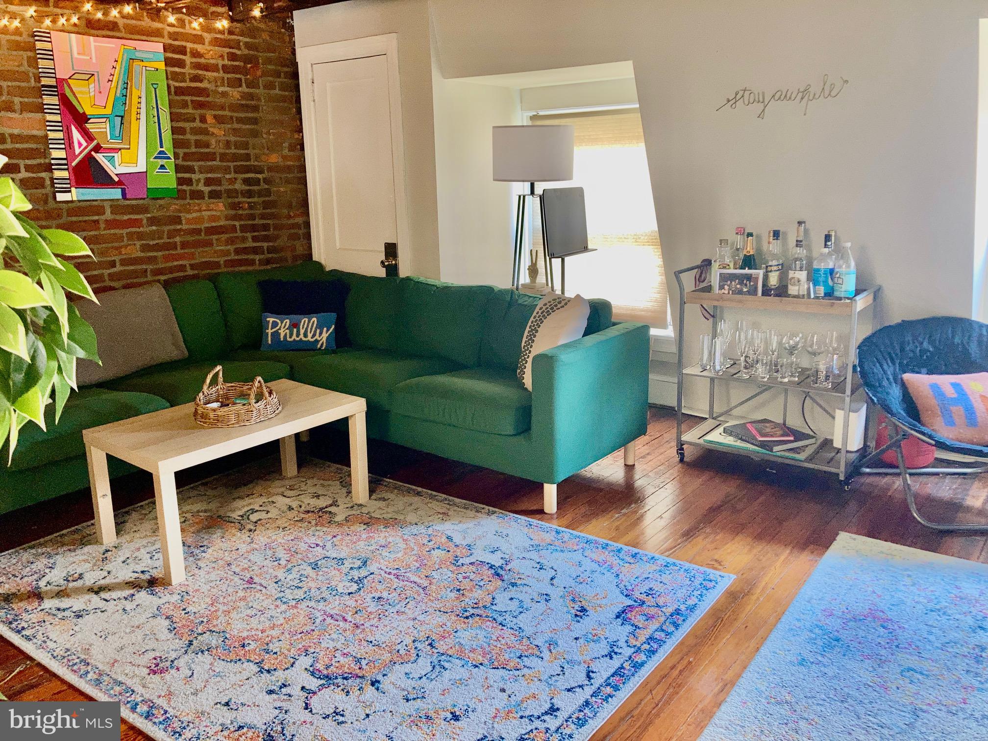 928-930 Pine Street, Unit 4R Philadelphia, PA 19107 - Photo 2 of 15 a living room with furniture and a wooden floor