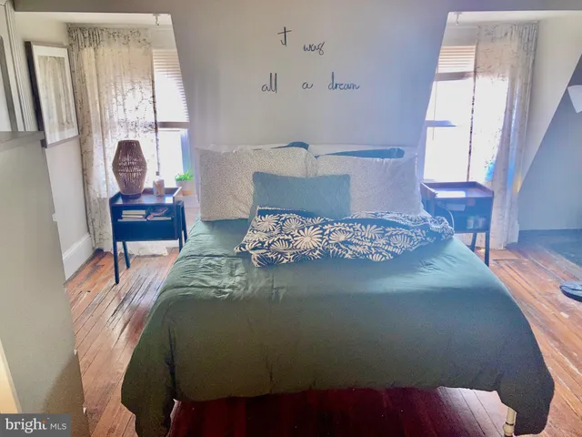 a bed sitting in a bedroom next to a window