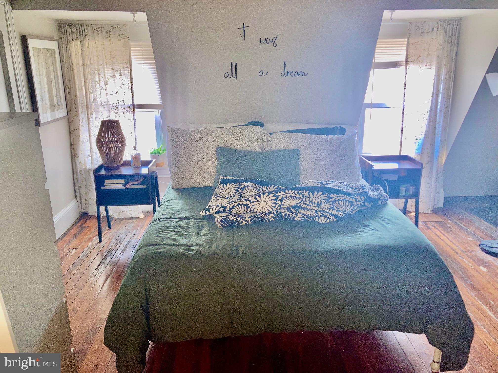 928-930 Pine Street, Unit 4R Philadelphia, PA 19107 - Photo 4 of 15 a bed sitting in a bedroom next to a window