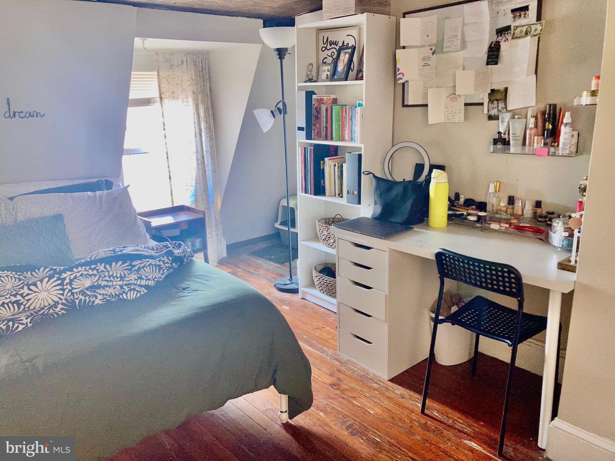 928-930 Pine Street, Unit 4R Philadelphia, PA 19107 - Photo 5 of 15 a bedroom with furniture and a book shelf