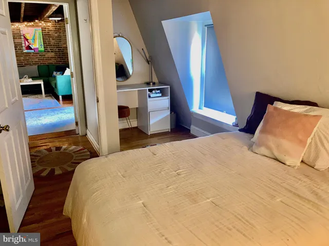 a bedroom with a bed and a mirror