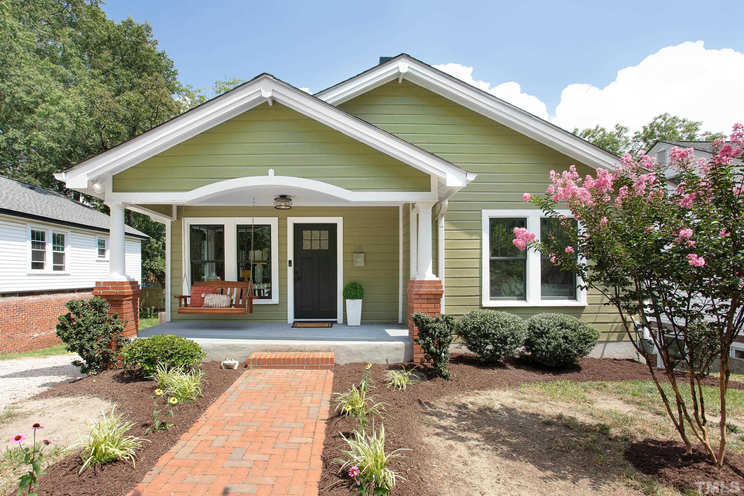 1218 North Roxboro Street Durham, NC 27701 - Photo 1 of 39 a front view of a house with garden
