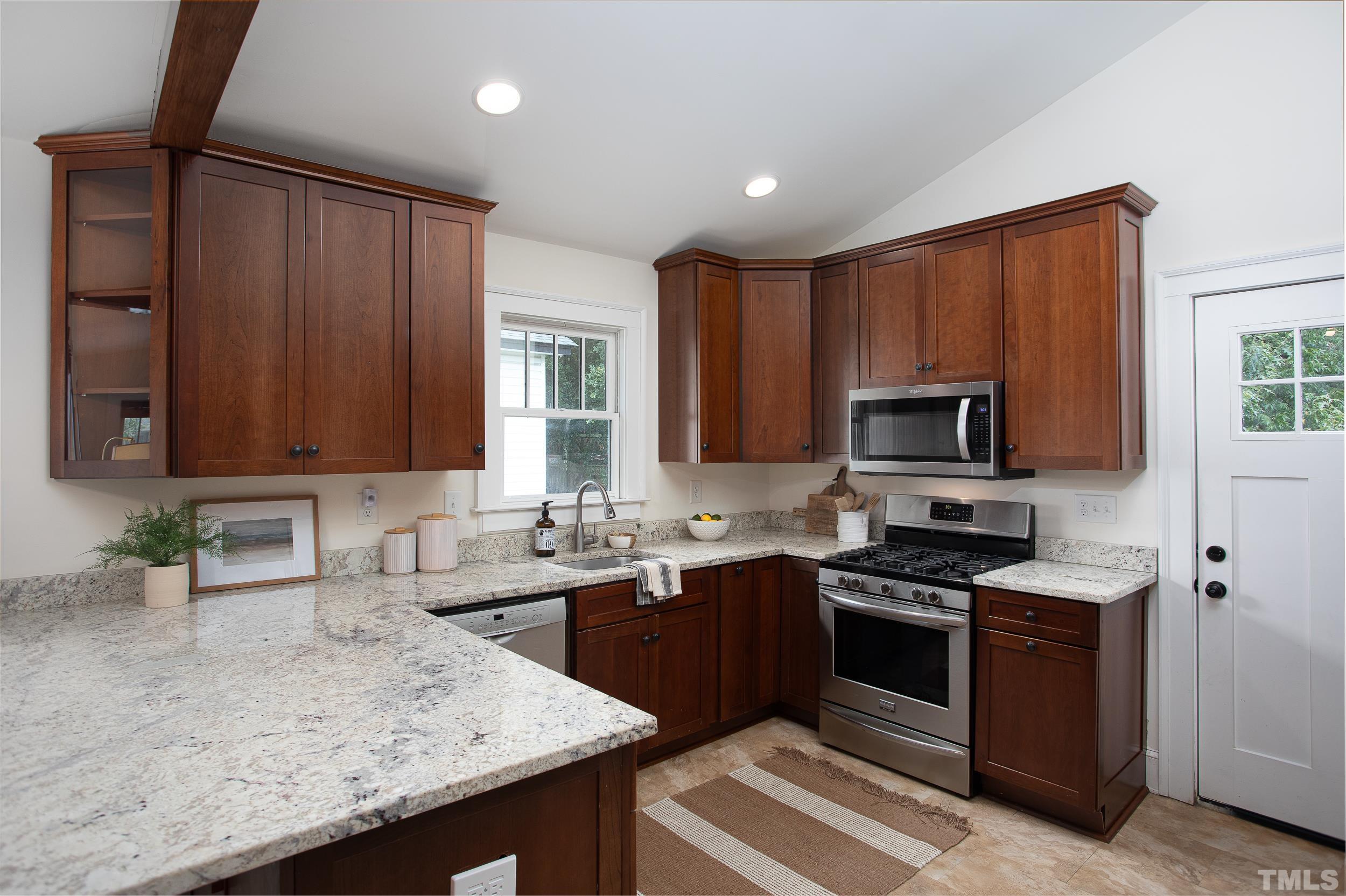 1218 North Roxboro Street Durham, NC 27701 - Photo 13 of 39 a kitchen with stainless steel appliances granite countertop a sink stove and microwave