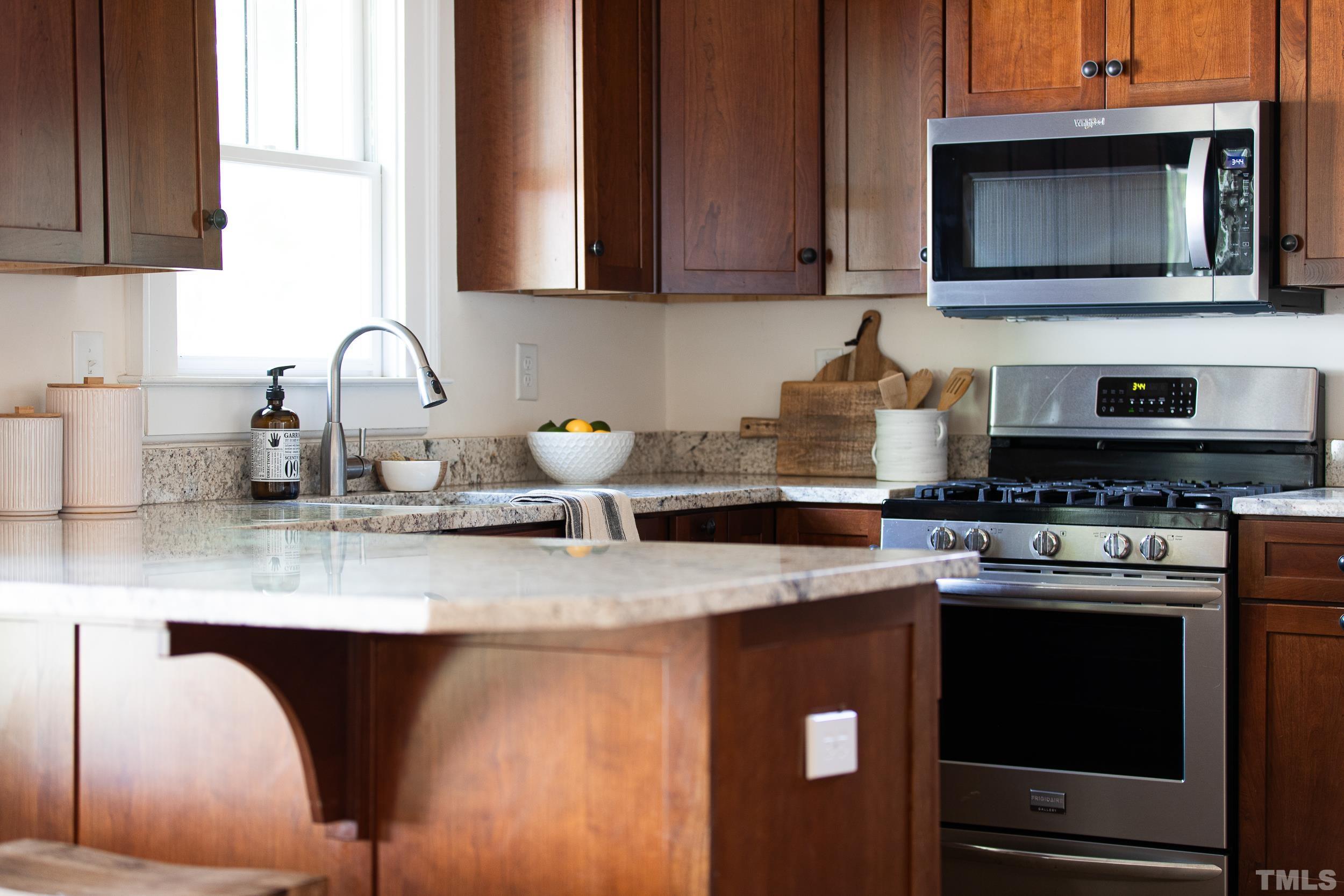 1218 North Roxboro Street Durham, NC 27701 - Photo 18 of 39 a kitchen with stainless steel appliances granite countertop a stove a sink and a microwave