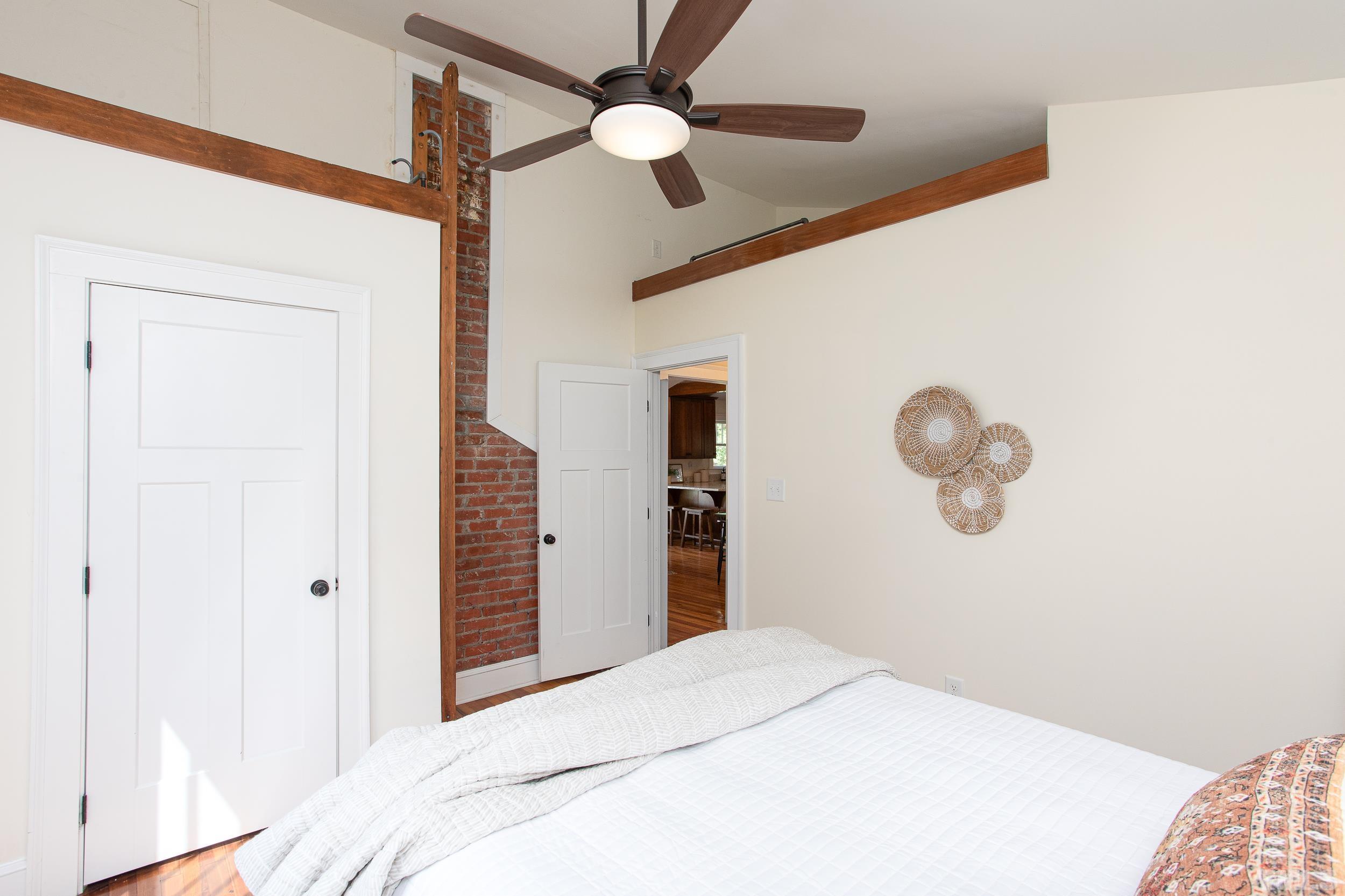 1218 North Roxboro Street Durham, NC 27701 - Photo 21 of 39 a bedroom with a bed and a chandelier