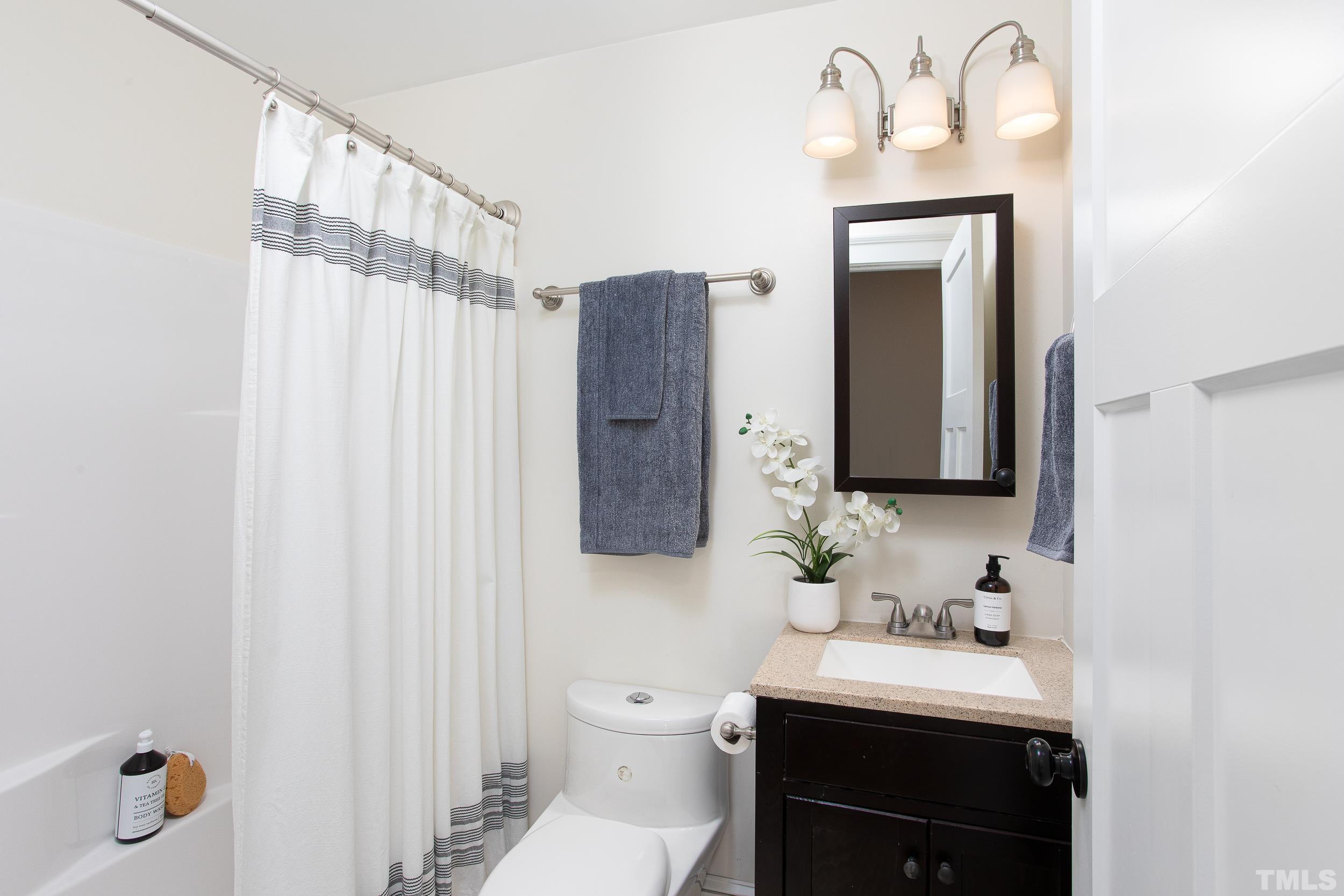 1218 North Roxboro Street Durham, NC 27701 - Photo 25 of 39 a bathroom with a sink vanity granite and toilet