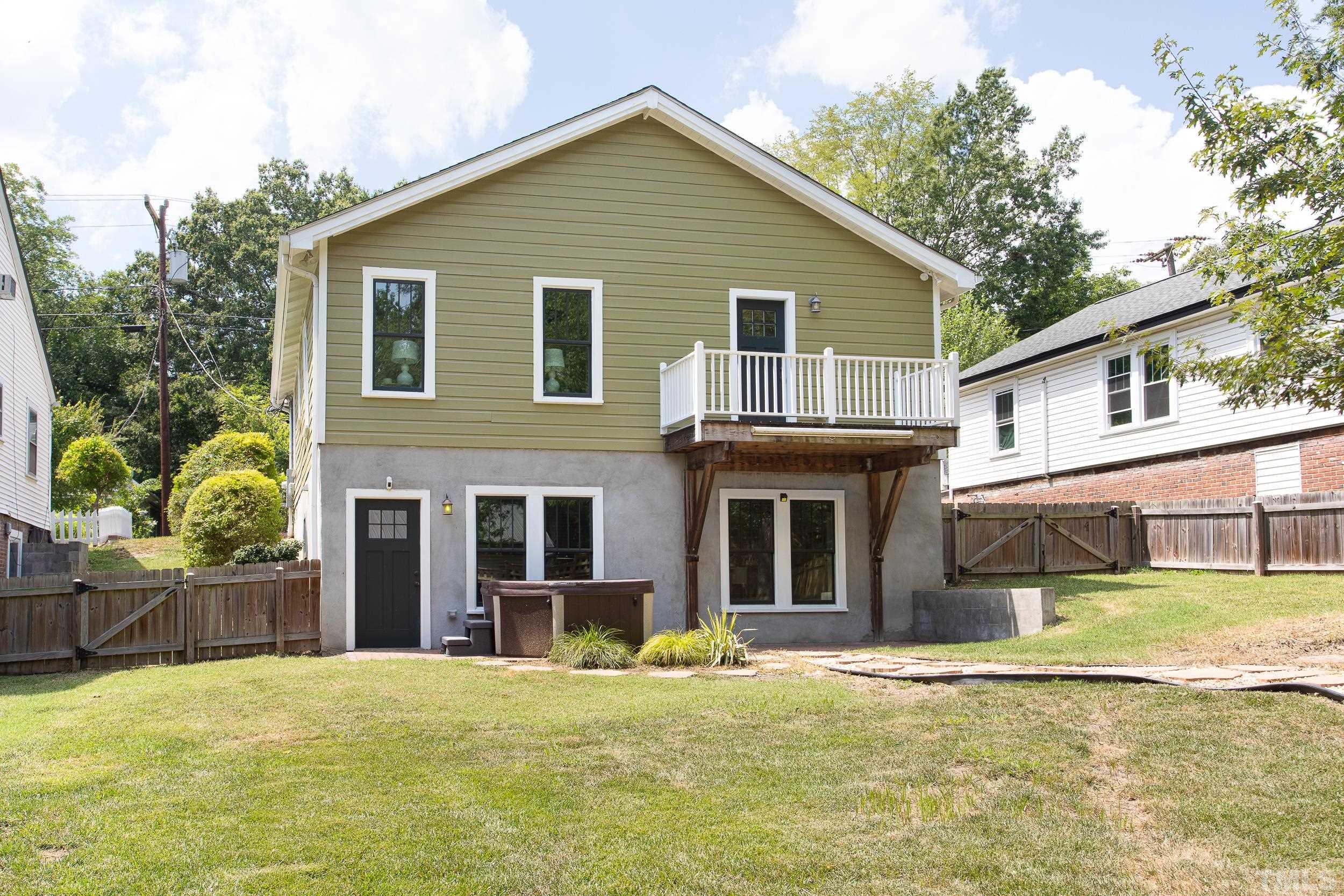 1218 North Roxboro Street Durham, NC 27701 - Photo 37 of 39 a front view of a house with a yard and garage