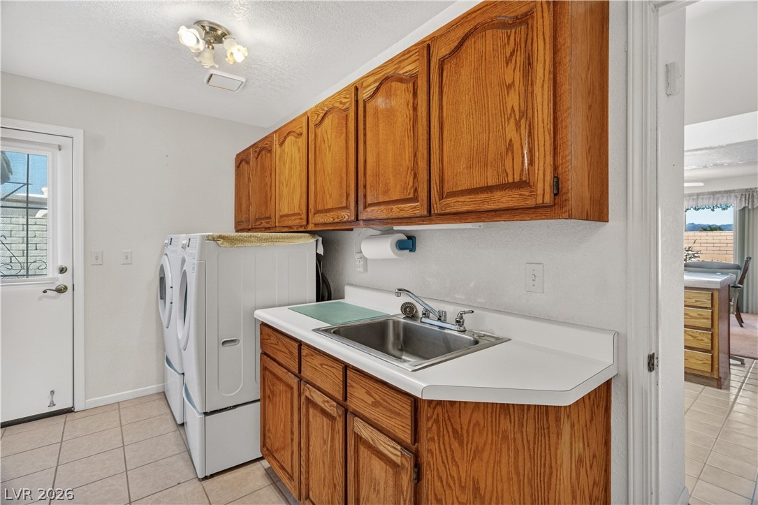 2055 Cholla Way Laughlin, NV 89029 - Photo 40 of 87 A well-appointed utility room features abundant cabinetry and a convenient sink, perfect for all laundry needs.