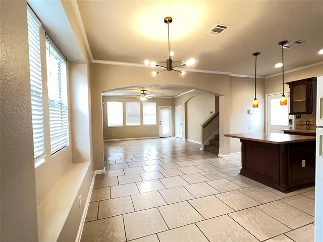 a view of kitchen with windows and chandelier