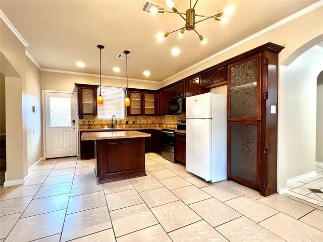 a kitchen with stainless steel appliances granite countertop a refrigerator and a sink