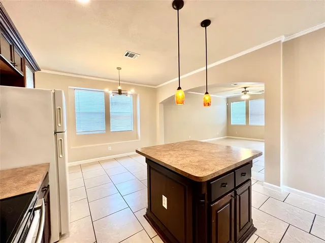 a kitchen with a sink a counter space and wooden floor