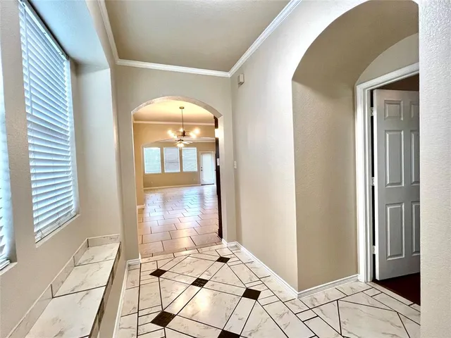 a view of a hallway with wooden floor and a livingroom