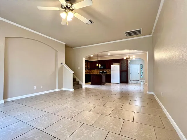 a view of an empty room with cabinet and a window