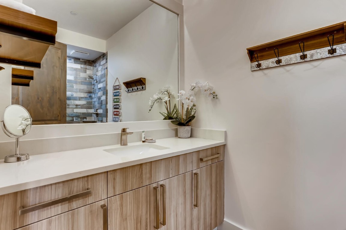 117 Lake Ridge Circle, Unit 1863 Keystone, CO 80435 - Photo 23 of 38 a bathroom with a sink and a mirror