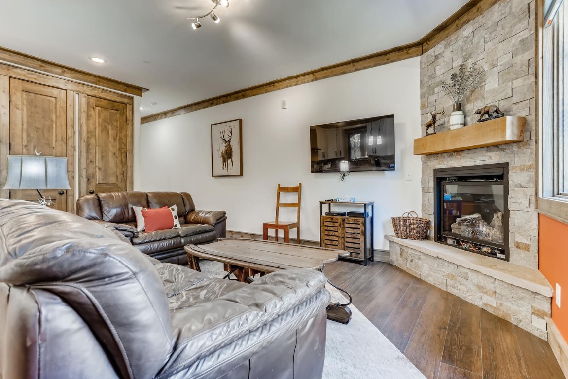 117 Lake Ridge Circle, Unit 1863 Keystone, CO 80435 - Photo 27 of 38 a living room with fireplace furniture and a flat screen tv