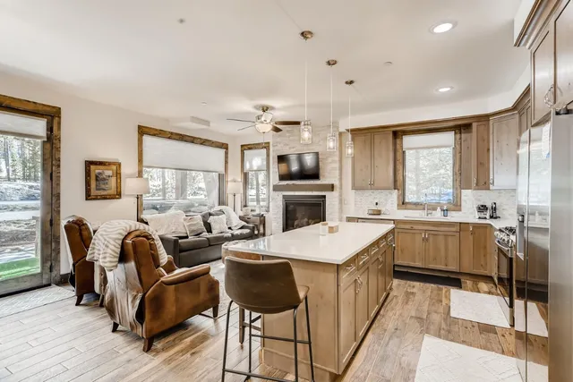 a kitchen with stainless steel appliances a stove sink microwave and cabinets