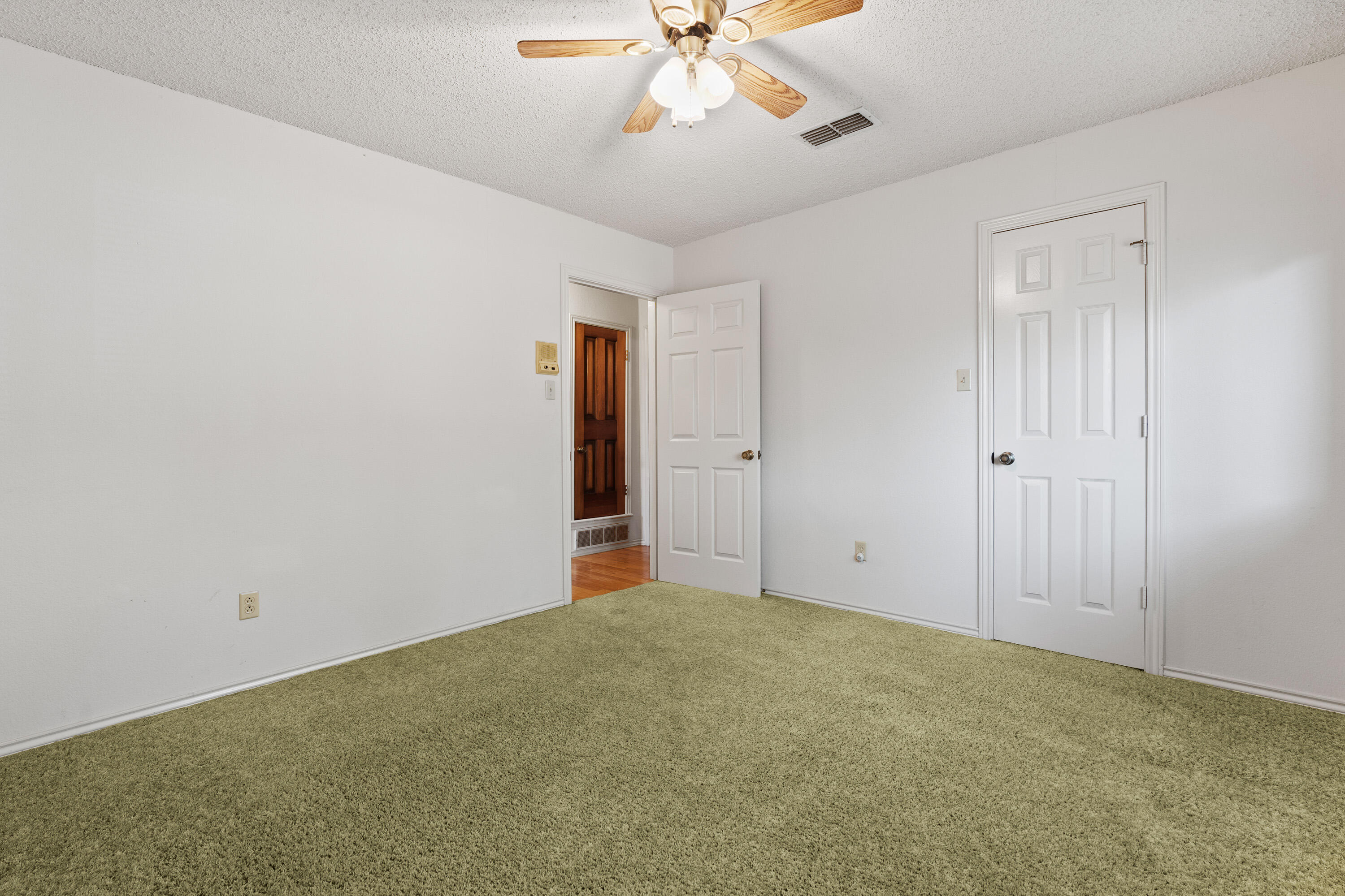 8016 Dover Avenue Lubbock, TX 79424 - Photo 18 of 25 a view of an empty room with a ceiling fan
