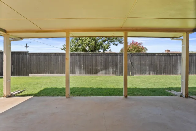 a view of a back yard and a fence