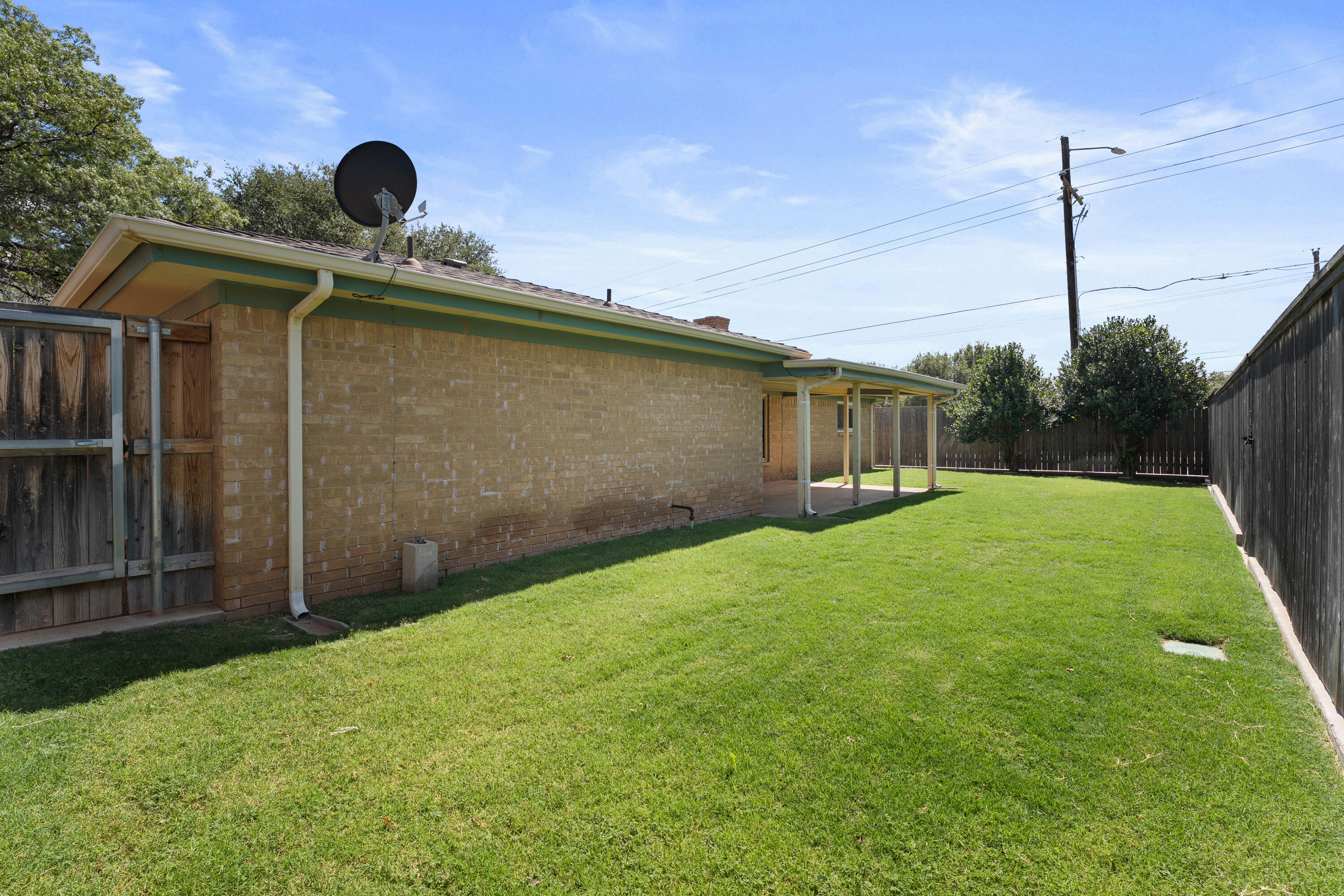 8016 Dover Avenue Lubbock, TX 79424 - Photo 24 of 25 a backyard of a house with a garden and barbeque oven