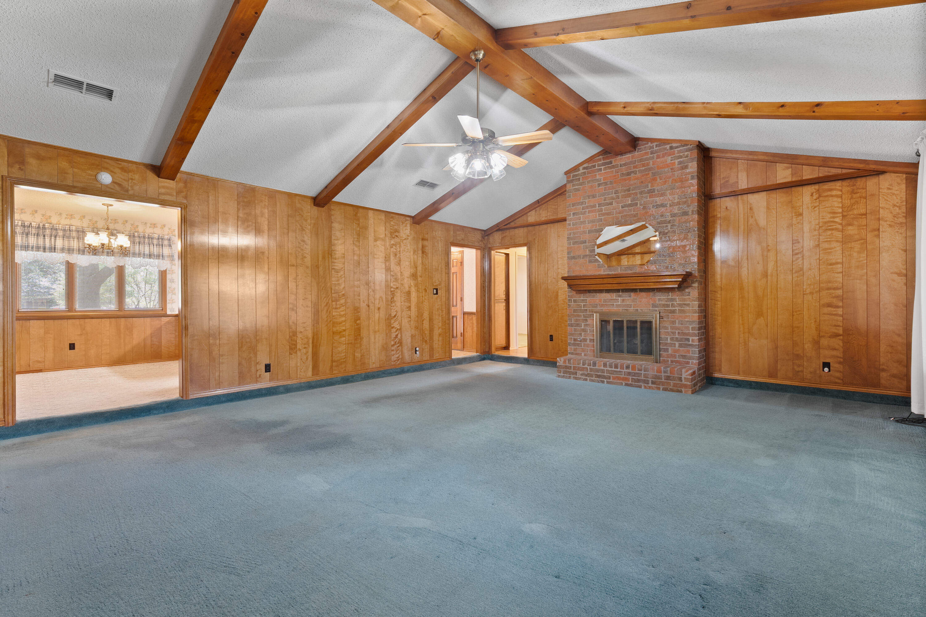 8016 Dover Avenue Lubbock, TX 79424 - Photo 6 of 25 a view of an empty room with a fireplace and a window