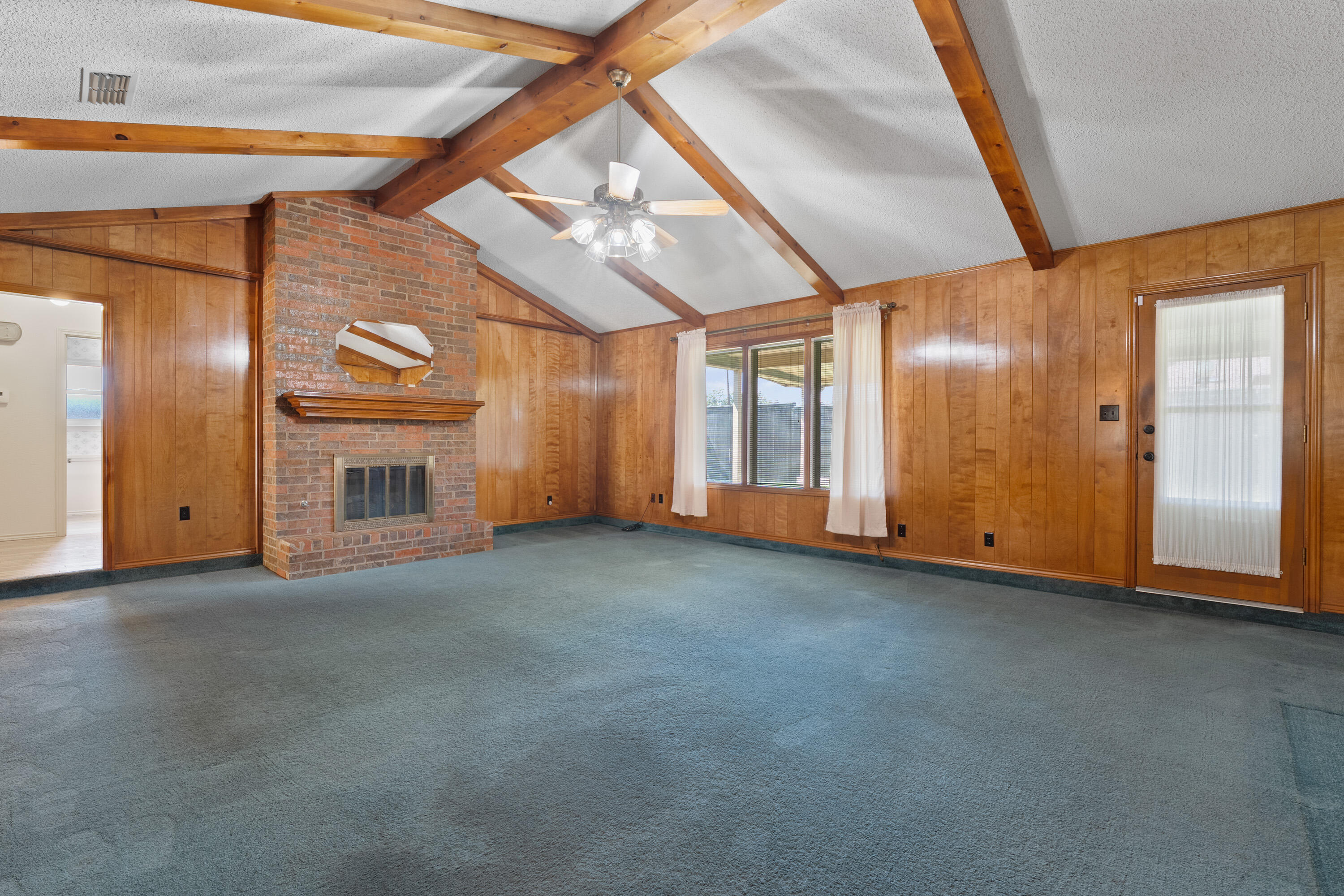 8016 Dover Avenue Lubbock, TX 79424 - Photo 7 of 25 a view of an empty room with a fireplace and a window