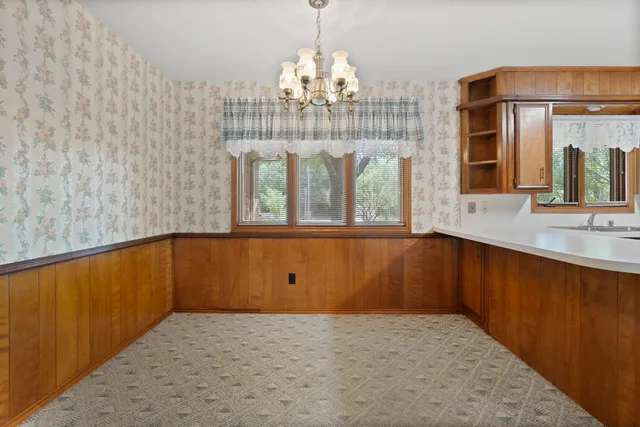 a bathroom with a sink a mirror and a window