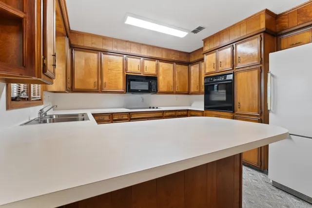 a kitchen with stainless steel appliances a refrigerator sink and cabinets