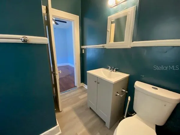 a bathroom with a sink a toilet and a mirror