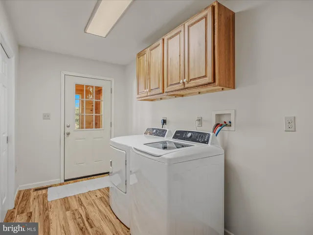 a view of a room with wooden floor and fan