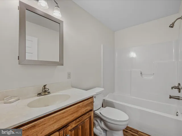 a view of a room with wooden floor and fan