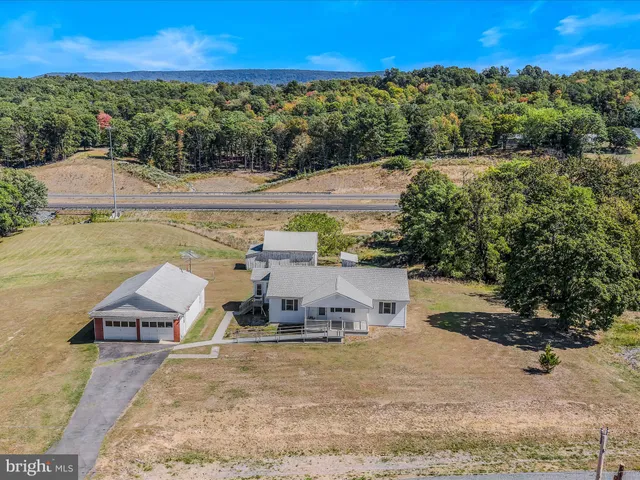 an aerial view of a house with a yard and lake view