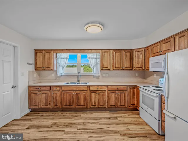 a kitchen with appliances cabinets and a sink