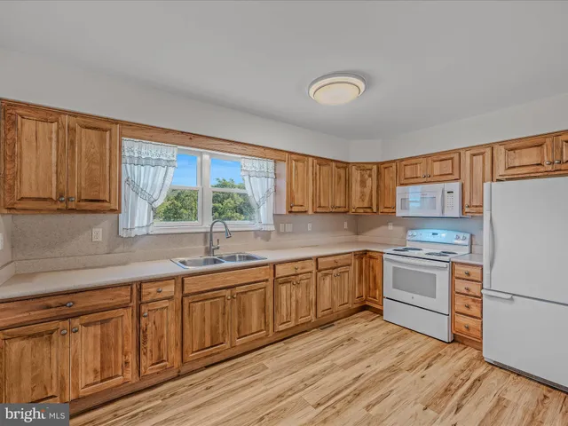 a view of a kitchen with a stove cabinets and wooden floor