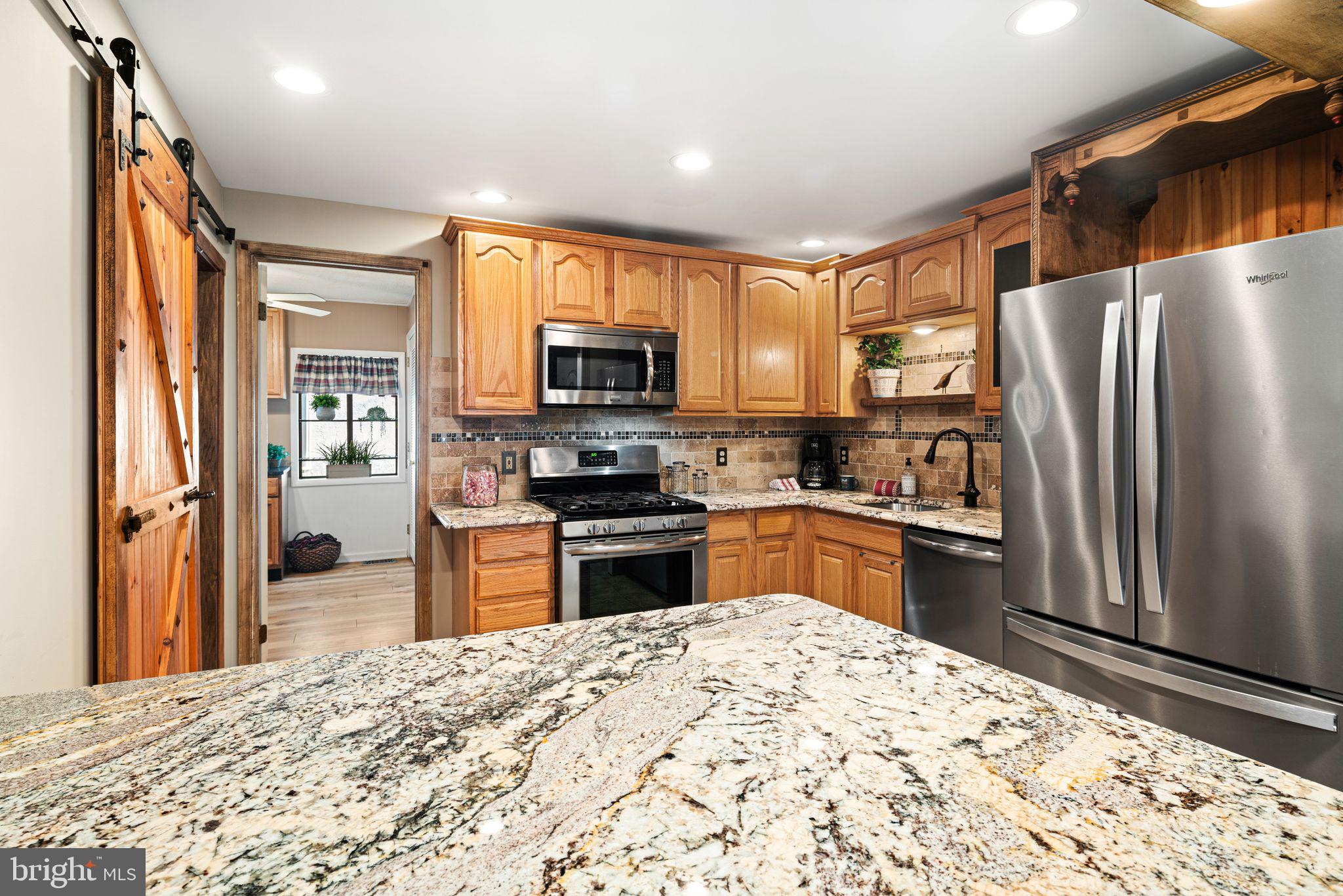 426 Avondale Avenue Haddonfield, NJ 08033 - Photo 11 of 40 a kitchen with granite countertop a refrigerator and a stove top oven