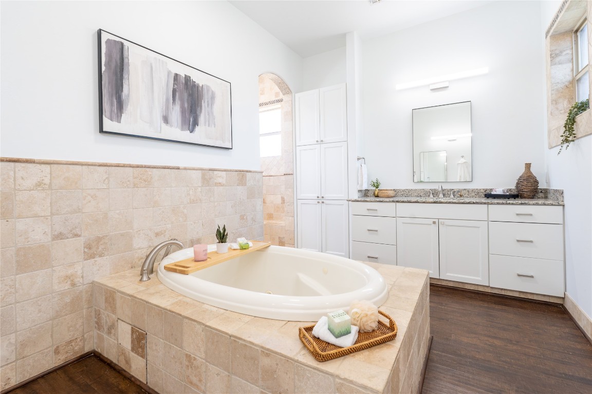 724 Chama Trace Dripping Springs, TX 78620 - Photo 15 of 40 a bathroom with a sink and a mirror