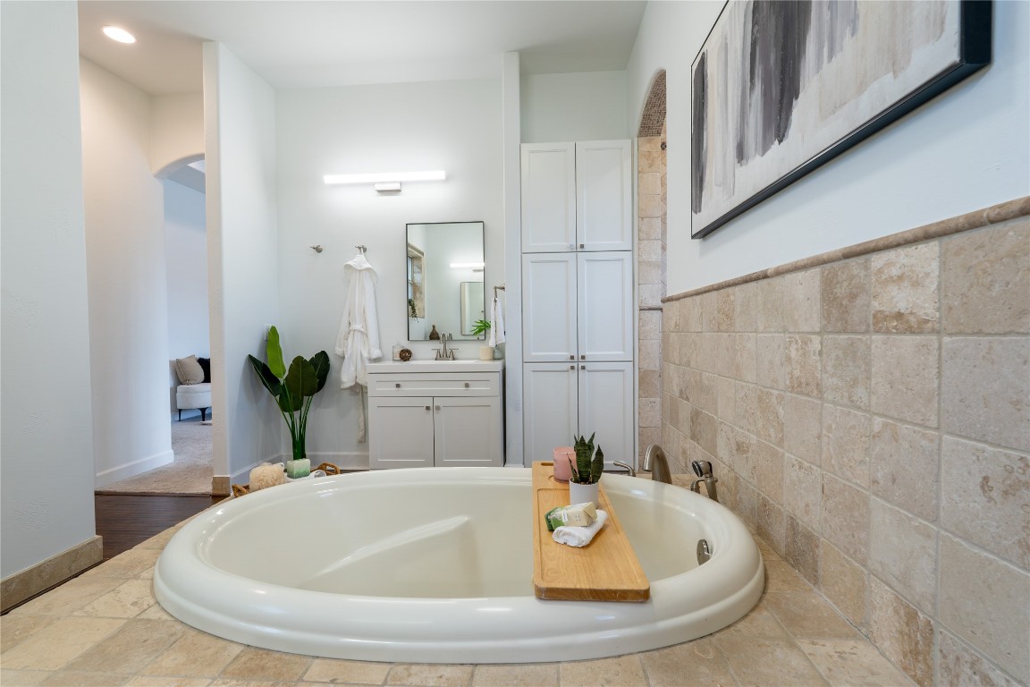 724 Chama Trace Dripping Springs, TX 78620 - Photo 16 of 40 a bathroom with a tub and sink