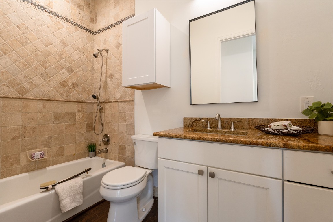 724 Chama Trace Dripping Springs, TX 78620 - Photo 19 of 40 a bathroom with a granite countertop sink mirror vanity and toilet
