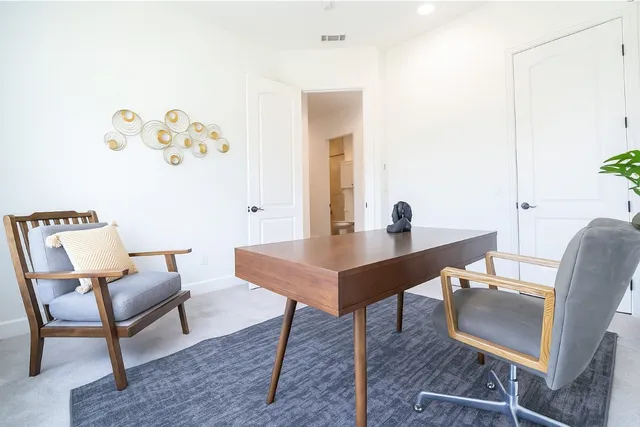 a bedroom with a bed and large windows