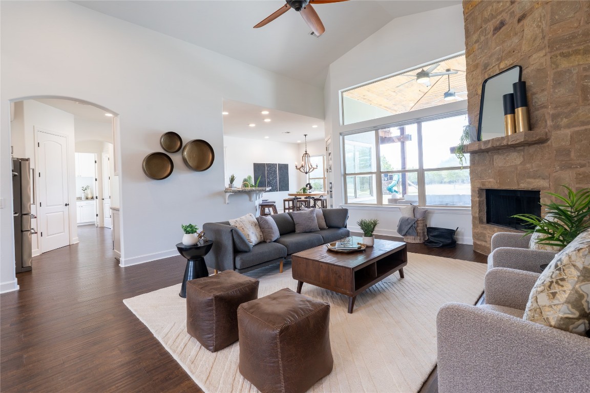 724 Chama Trace Dripping Springs, TX 78620 - Photo 3 of 40 a living room with furniture kitchen view and a fireplace