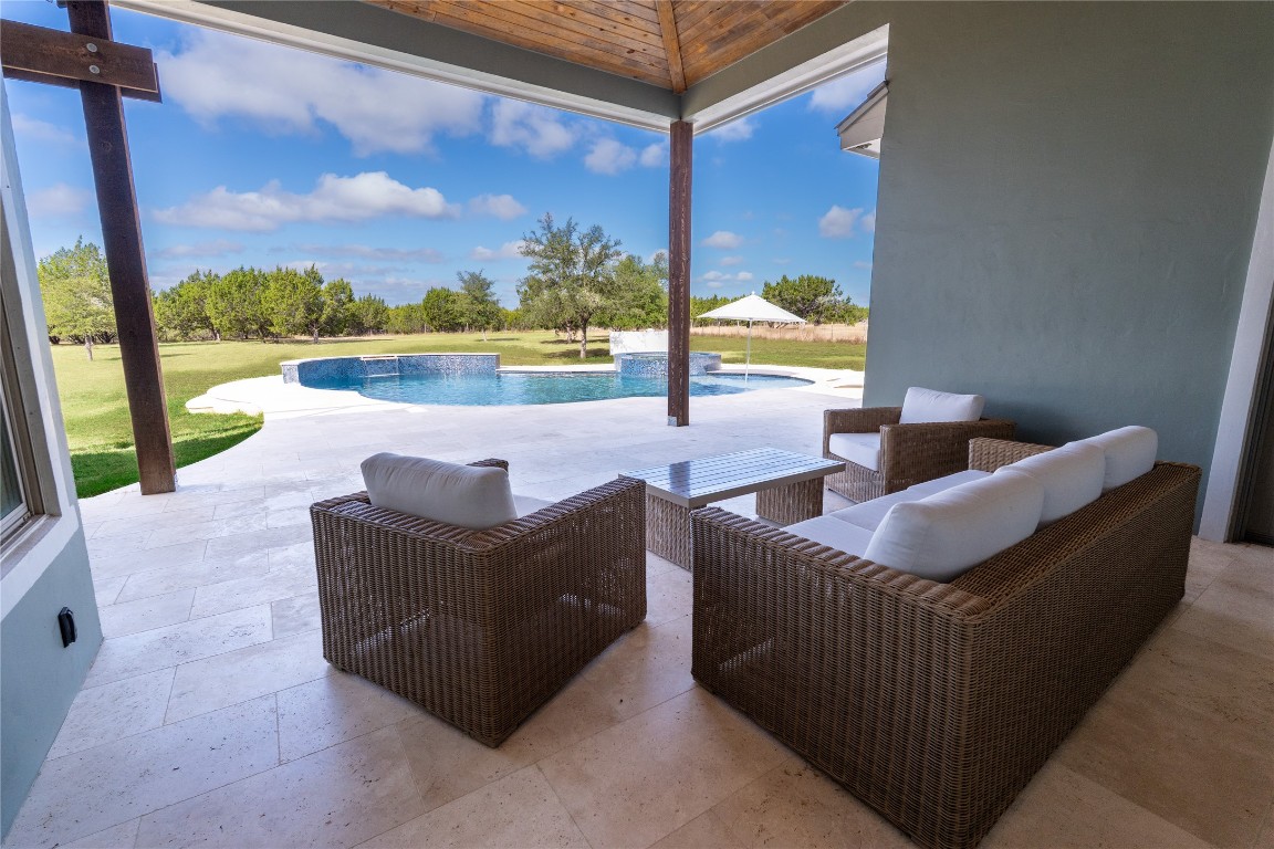 724 Chama Trace Dripping Springs, TX 78620 - Photo 34 of 40 a living room with couch and a floor to ceiling window