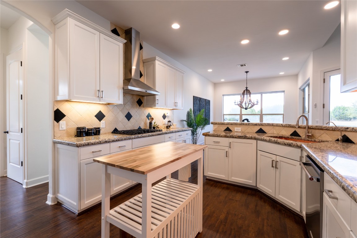 724 Chama Trace Dripping Springs, TX 78620 - Photo 8 of 40 a kitchen with white cabinets and sink