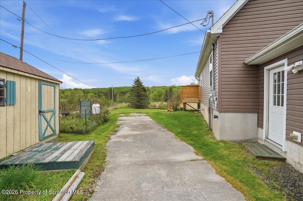 5231 Fiddle Lake Road Thompson, PA 18465 - Photo 29 of 34 a front view of a house with a yard and garage