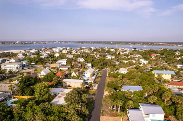 an aerial view of residential building and lake