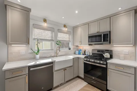 a kitchen with a sink stove and microwave